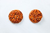 Two cookies with caramelised peanuts