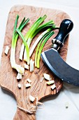 Chopped spring onions on a wooden board