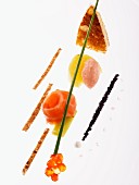 An artistic arrangement of smoked salmon, tamaras, salmon caviar and strips of toast