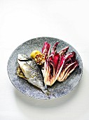 Grill radicchio with lemon oil and a fish filled with lemon and thyme