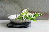 Lily of the valley in metal dish