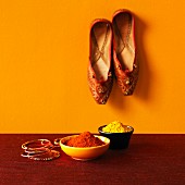 An arrangement featuring Indian spices, bangles and slippers