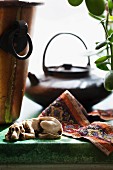 Teapot and dog ornament in front of window