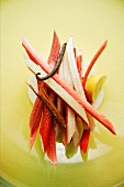 Sliced rhubarb with cinnamon sticks, lemon and a vanilla pod