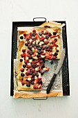 A sweet berry pizza on a baking tray