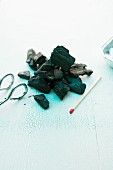 Coal, a match and a pair of tongs