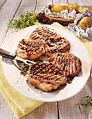 Wild boar steaks with a thyme and juniper berry marinade served with baked potatoes