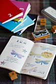 Nostalgic wooden stamps with butterfly and number motifs, various books and prints in open book
