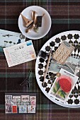 Collection of craft utensils, nostalgic postage stamps, postcards, buttons and stamps