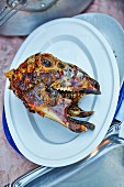 A grilled lamb's head on a plate