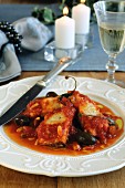 Stockfish in tomato sauce with raisins, pine nuts and capers