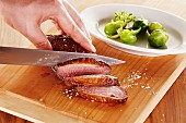 Roasted duck breast being sliced