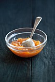 Persimmon jam with ginger in a small glass bowl
