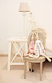 Rabbit soft toys on vintage chair and rustic bedside table with table lamp