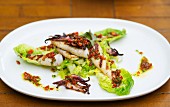 Grilled squid with vinaigrette on a bed of lettuce