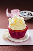 A strawberry cupcake decorated with white chocolate