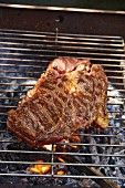 Barbecued beef steak on the barbecue
