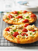 Mini pizzas with crab, cherry tomatoes and garlic