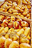 Various bread rolls in baskets in a bakers