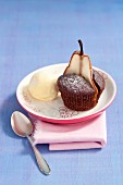 A chocolate muffin with a slice of pear and a scoop of vanilla ice cream