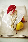 Gorgonzola, pears and a radicchio leaf on a linen cloth