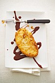 Mango escalope with a coconut coating and chocolate and ginger sauce