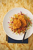Turkey escalope with a cornflakes coating served with a colourful raw vegetable salad