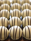 White chocolate pralines with dark chocolate stripes