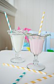 Two milkshakes with straws