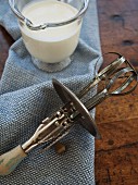 An old hand mixer and liquid cream