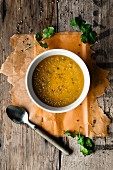 Carrot and coriander soup on a rustic wooden surface