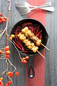 Fried chicken skewers with chilli peppers