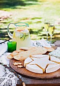 Pita bread, star shaped brie cheese & lemonade on outdoor table