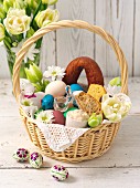 An Easter basket filled with bread, sausage and eggs