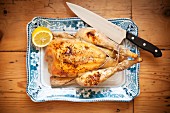 Roast chicken with lemon on a serving platter