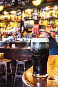 A freshly drawn pint of Guinness on a bar in a pub