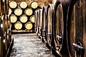 Wooden barrels in a wine cellar (barrique cellar)