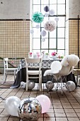 Vintage industrial interior used as party location with delicate, romantic decorations and disco ball