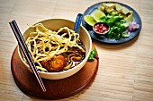 Khao Soi - crispy fried egg noodles with shallots and meat curry (Asia)