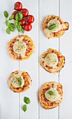 Mini pizzas topped with goat's cheese and bacon
