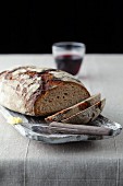 Sliced bread with red wine and a knife with butter