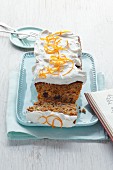 Carrot cake with white frosting and orange zest