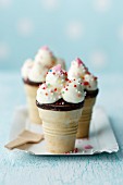 Cupcakes in ice cream cones decorated with sugar pearls