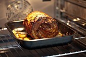 Roast pork roulade in an oven