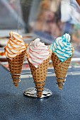 Three cones of soft serve ice cream