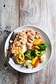 Fried salmon with vegetables (broccoli, cauliflower and carrots)