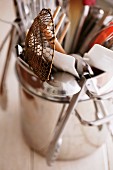 Various kitchen utensils in a metal pot