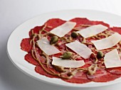 Salami carpaccio with cheese and capers