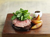 Beefsteak and chips on wooden board