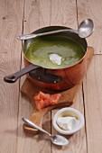 Spinach curry soup with smoked salmon and creme fraiche